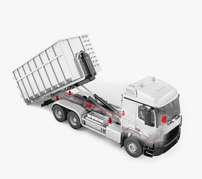 Ein Lkw, der mit integrierter PFREUNDT-Wägetechnik ausgestattet ist, wie die rot markierten Komponenten zeigen.