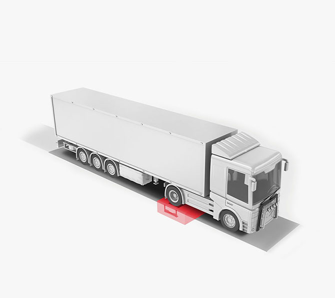 A truck on a road featuring a marked axle load scale from PFREUNDT, a specialist in mobile weighing systems.