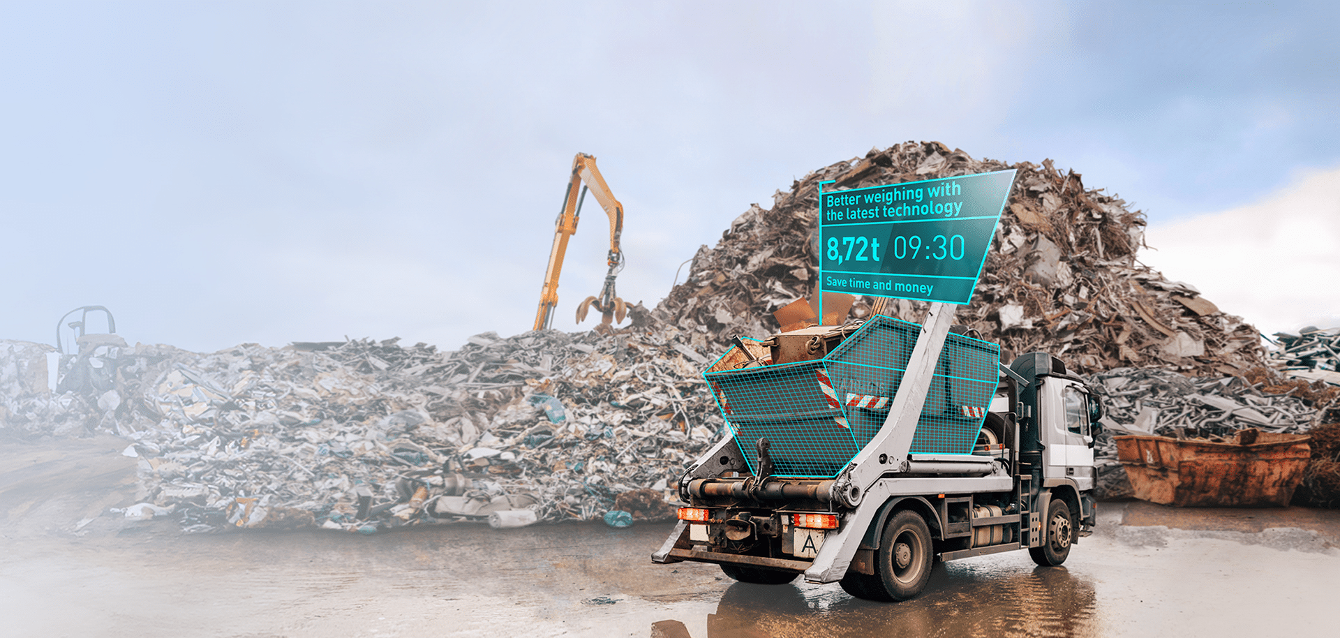 A lorry with a rubble container at a scrap yard; a screen displays the weight and the time; the PFREUNDT mobile weighing system is integrated.