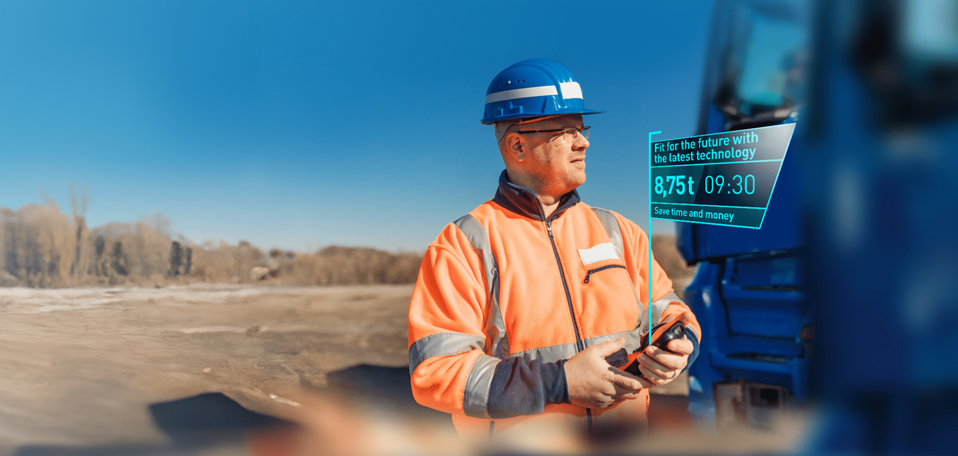 A worker wearing a hard hat uses PFREUNDT’s mobile weighing system on a building site to obtain precise measurements.