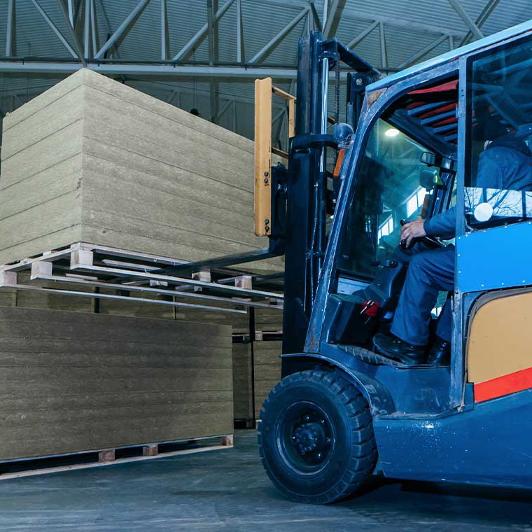 Forklift with PFREUNDT Forklift Scale transporting pallets in a warehouse.