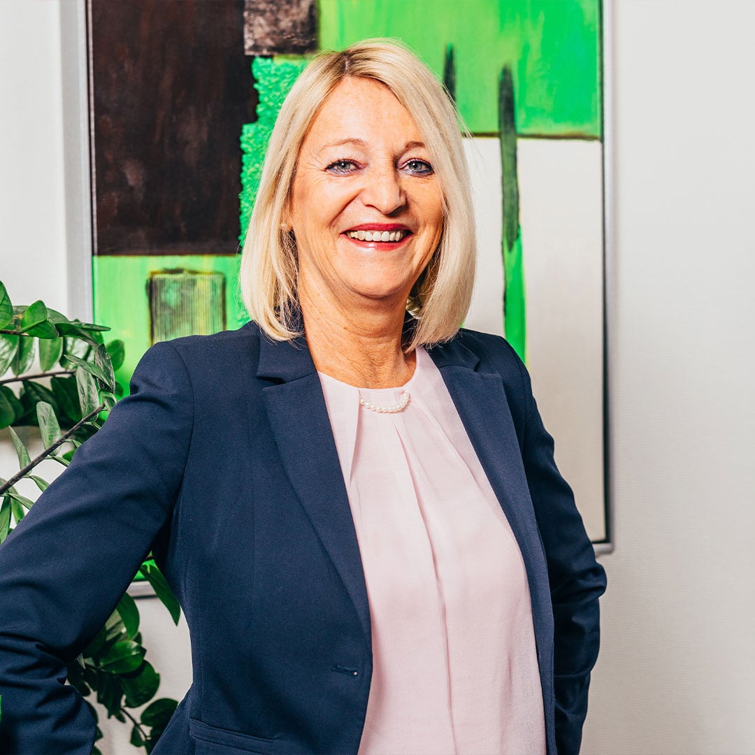 A businesswoman in the office of PFREUNDT, a specialist in mobile weighing systems such as excavator scales and belt scales.