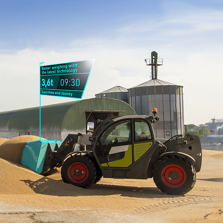 A telescopic loader fitted with a PFREUNDT weighing system loads grain and displays the weight and time via augmented reality.